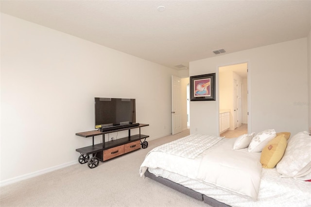 bedroom with baseboards, visible vents, and light colored carpet