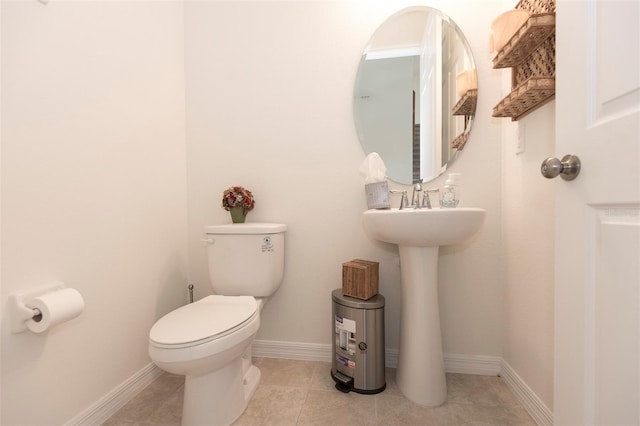 bathroom with tile patterned floors, toilet, and baseboards