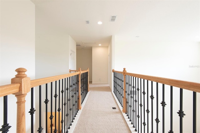 corridor with recessed lighting, visible vents, and light colored carpet