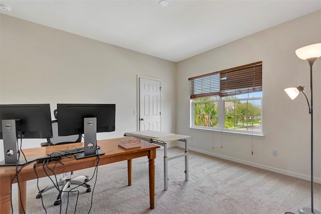 office featuring baseboards and light colored carpet