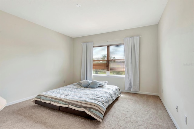 carpeted bedroom with baseboards