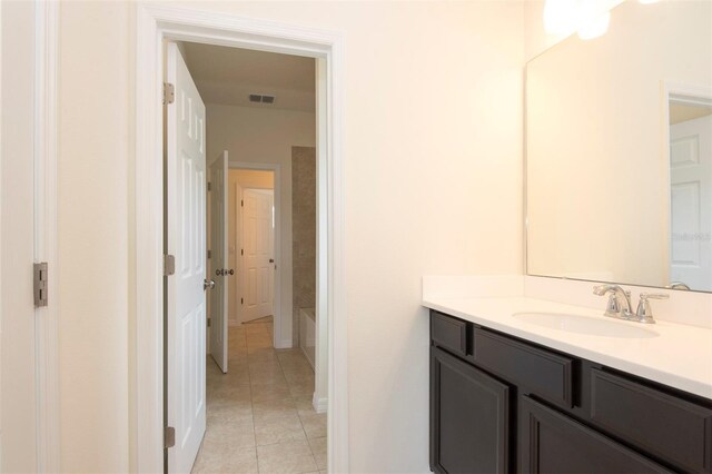 full bathroom featuring visible vents, vanity, and tile patterned floors