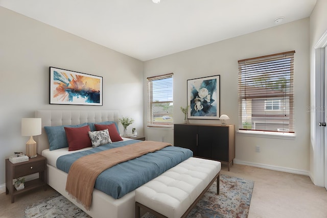 bedroom featuring baseboards and light colored carpet