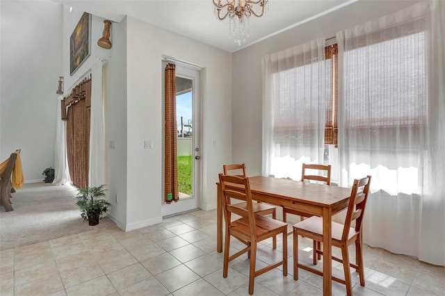 dining room featuring a chandelier, a healthy amount of sunlight, baseboards, and light tile patterned flooring