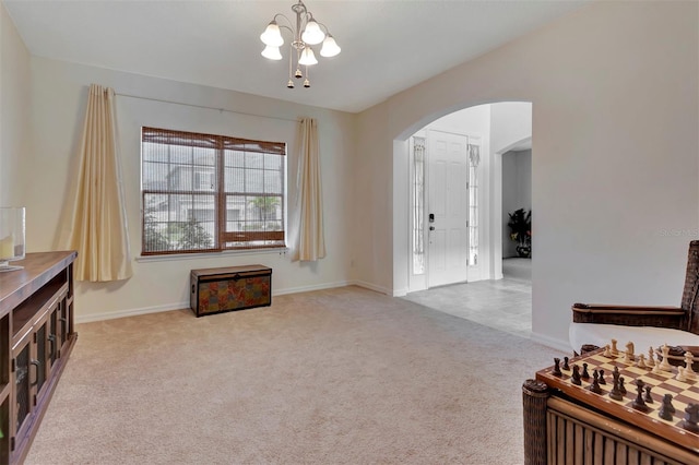 interior space with carpet, arched walkways, and baseboards