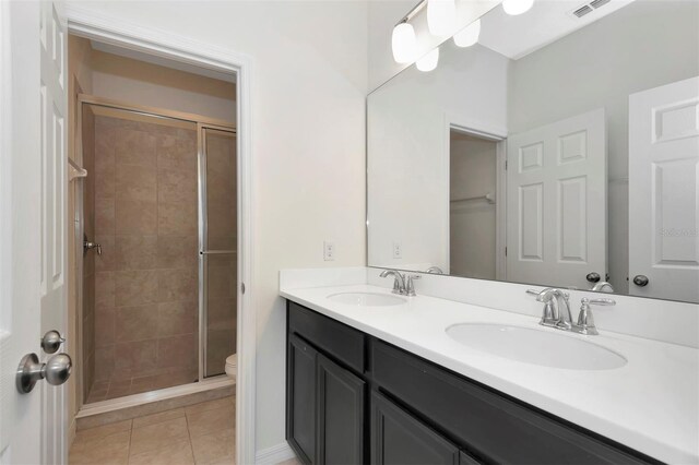 bathroom with tile patterned floors, a sink, visible vents, and a shower stall