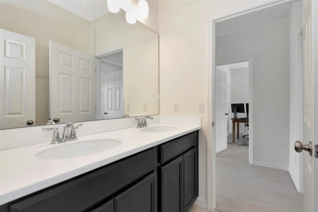 full bath featuring a sink, baseboards, and double vanity