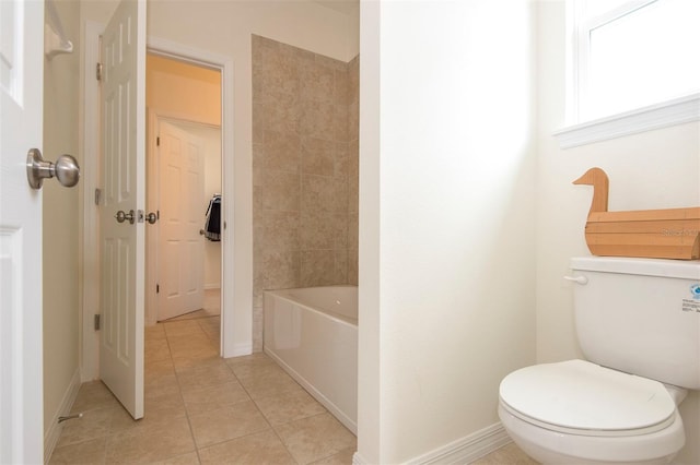 bathroom featuring baseboards, toilet, and tile patterned floors