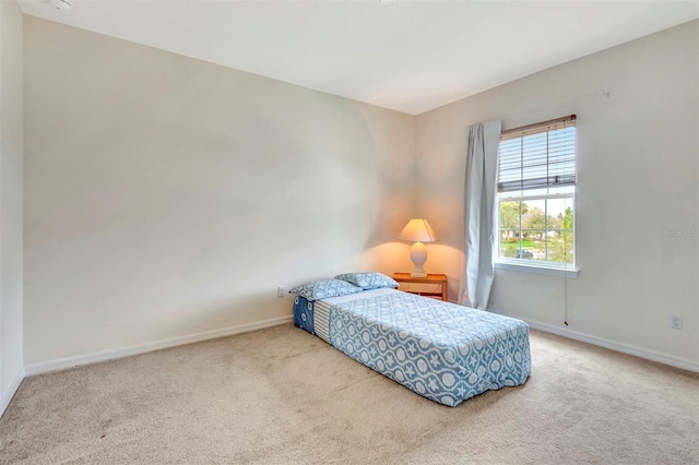 bedroom featuring carpet and baseboards