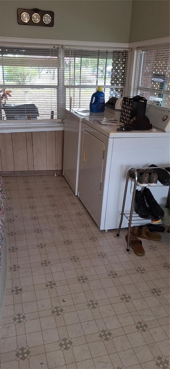 laundry area with laundry area, washer and clothes dryer, and light floors