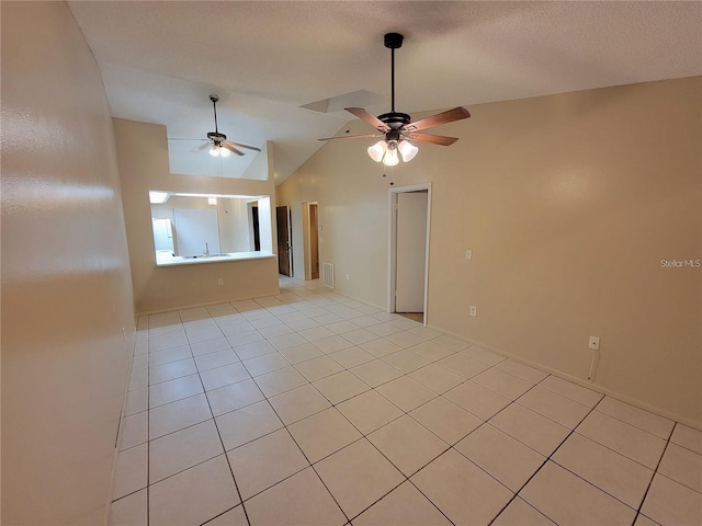 spare room featuring a ceiling fan, visible vents, vaulted ceiling, and a textured ceiling