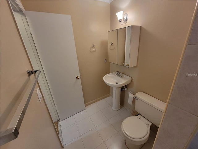 bathroom with toilet and tile patterned floors