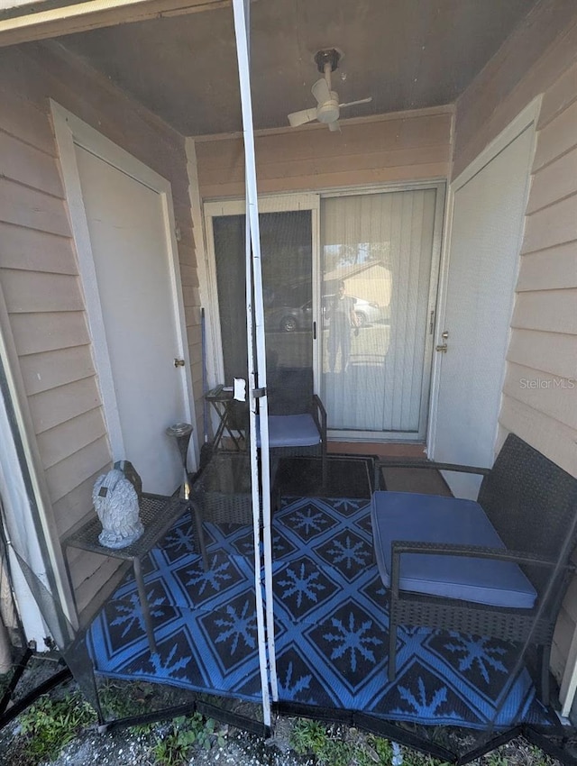 entrance to property with ceiling fan