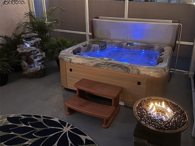 miscellaneous room featuring concrete flooring and a hot tub