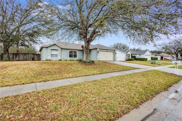 ranch-style home featuring concrete driveway, an attached garage, fence, a front lawn, and stucco siding