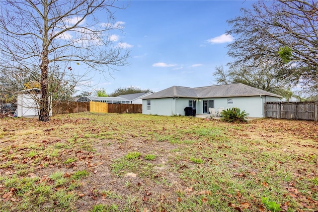 rear view of house featuring fence and stucco siding