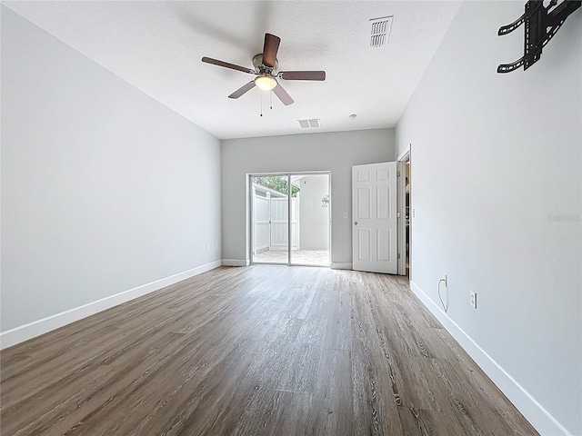 unfurnished room with visible vents, ceiling fan, baseboards, and wood finished floors