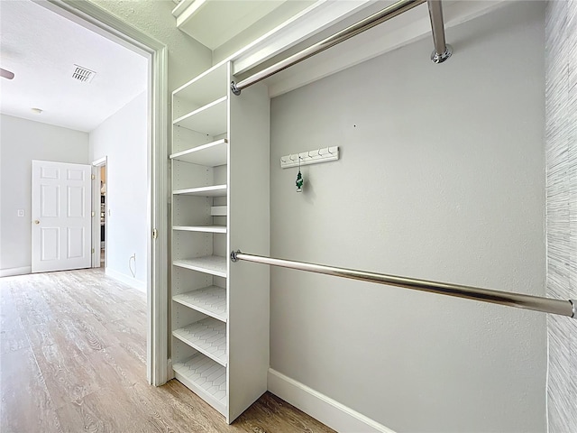 spacious closet with visible vents and wood finished floors