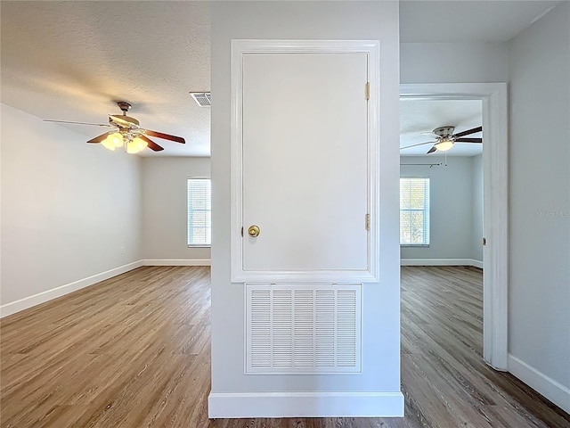 spare room with a healthy amount of sunlight, visible vents, and a textured ceiling