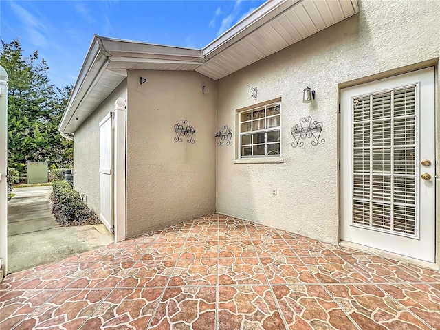 exterior space featuring stucco siding and a patio