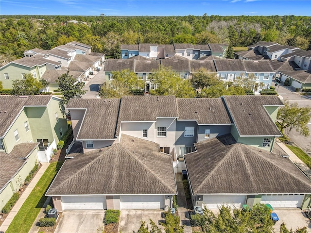 birds eye view of property with a residential view and a wooded view