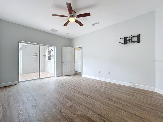 unfurnished bedroom with a ceiling fan, wood finished floors, baseboards, and visible vents