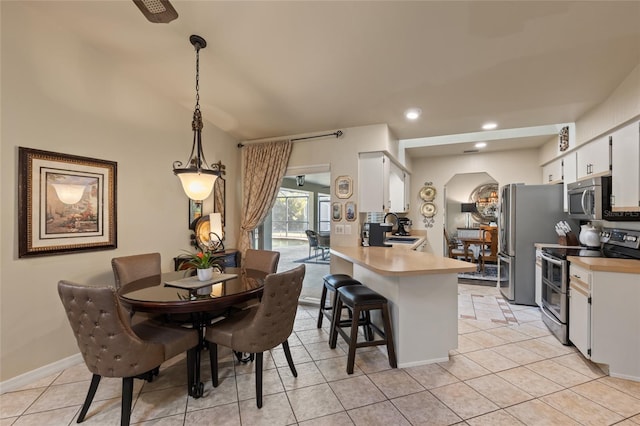 kitchen featuring white cabinetry, stainless steel appliances, a sink, and light countertops