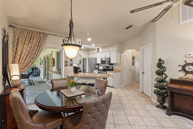 dining space with visible vents, ceiling fan, baseboards, and light tile patterned flooring