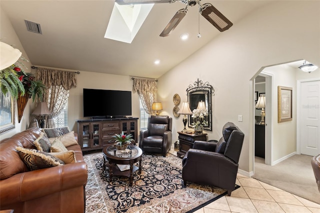 living area with arched walkways, lofted ceiling, light tile patterned flooring, light carpet, and visible vents