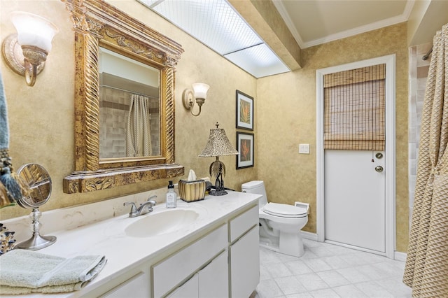 bathroom featuring ornamental molding, vanity, and toilet