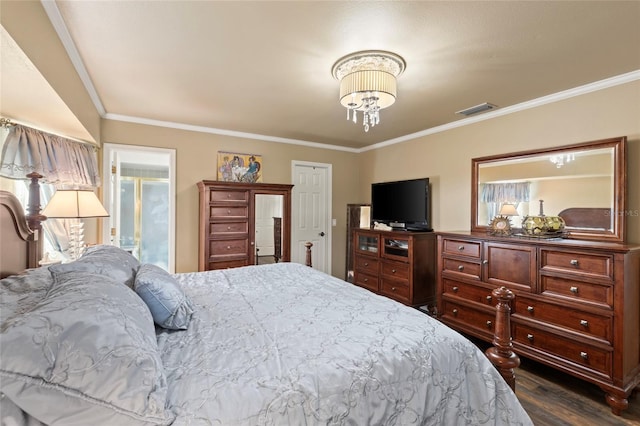 bedroom featuring ornamental molding, dark wood-style flooring, visible vents, and an inviting chandelier