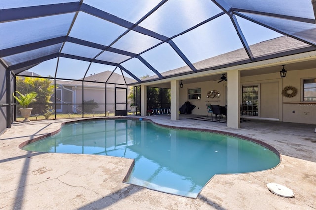 outdoor pool featuring a lanai, a patio area, and ceiling fan