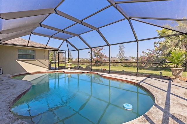 pool with glass enclosure and a patio area