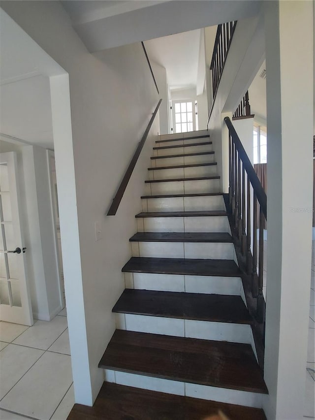 stairs with tile patterned flooring