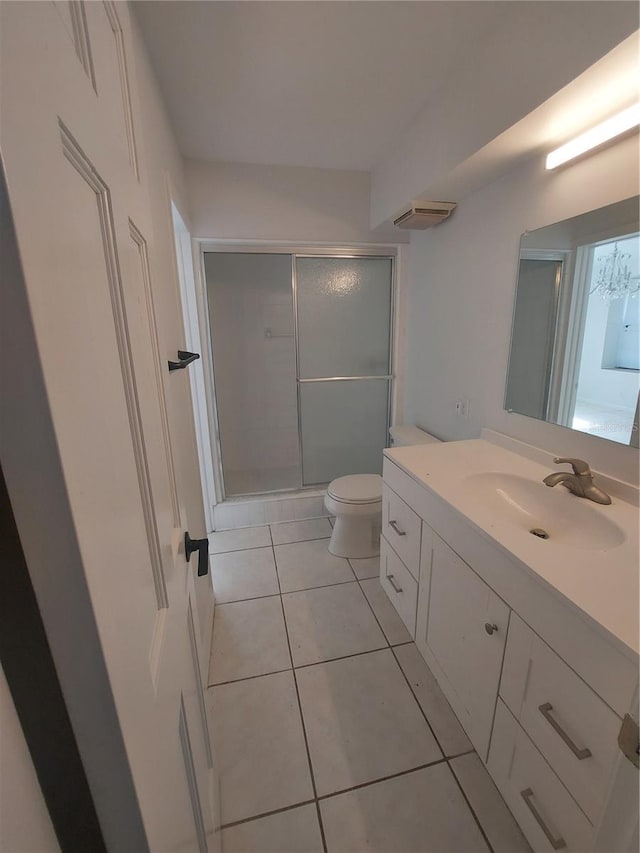 full bathroom with toilet, a shower stall, tile patterned flooring, and vanity