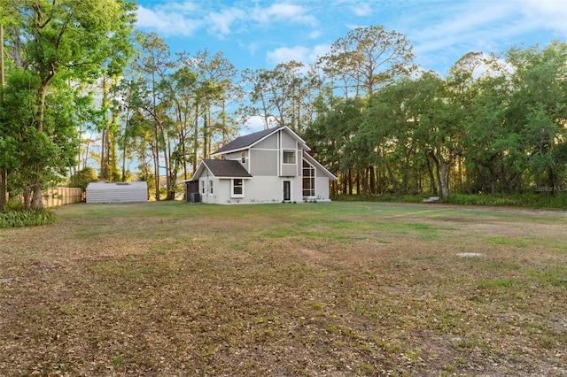 exterior space featuring an outdoor structure, a shed, and a lawn