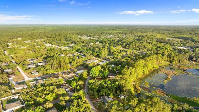 aerial view with a wooded view and a water view