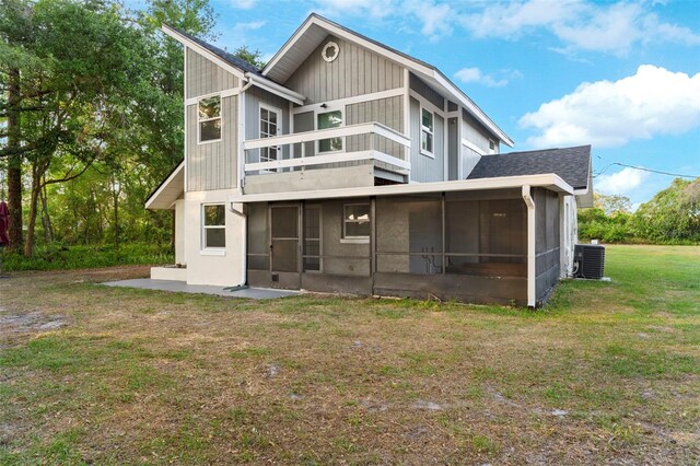 back of house with a balcony, a yard, central AC, a patio area, and a sunroom