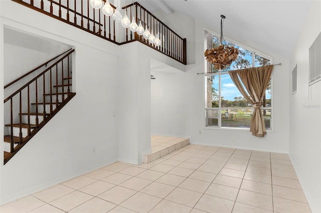 interior space with high vaulted ceiling, visible vents, tile patterned floors, stairway, and a notable chandelier