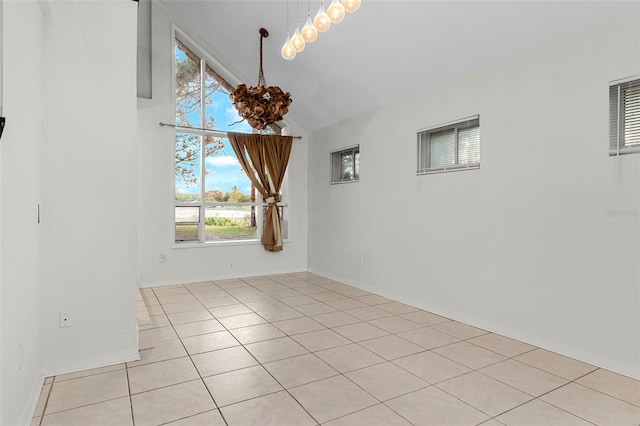 empty room with baseboards, light tile patterned flooring, and high vaulted ceiling
