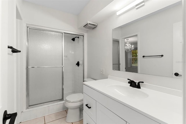 full bath with tile patterned floors, toilet, a stall shower, and vanity
