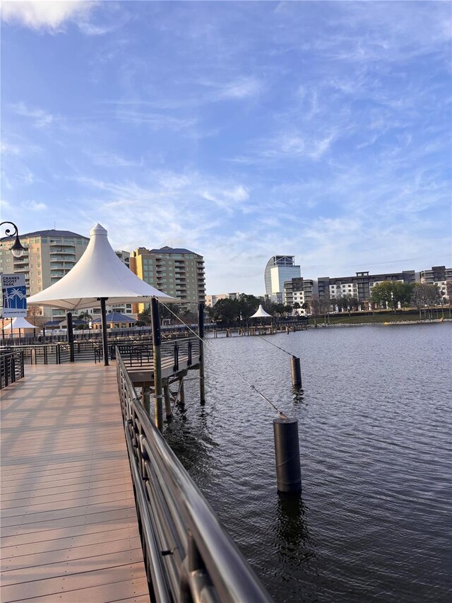 view of dock featuring a water view and a city view