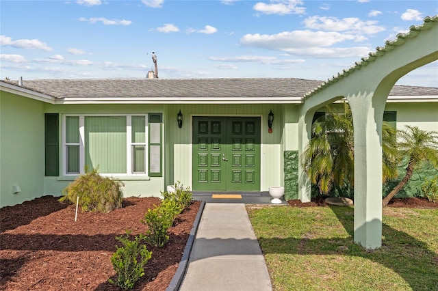 entrance to property with roof with shingles