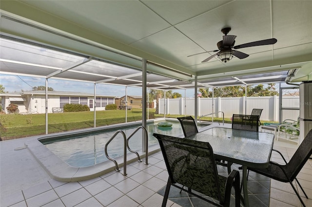 sunroom with ceiling fan, a swimming pool, and plenty of natural light