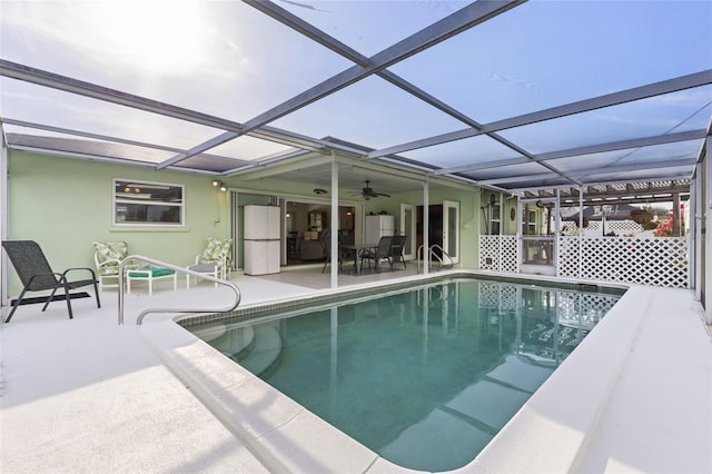 pool featuring a patio and glass enclosure