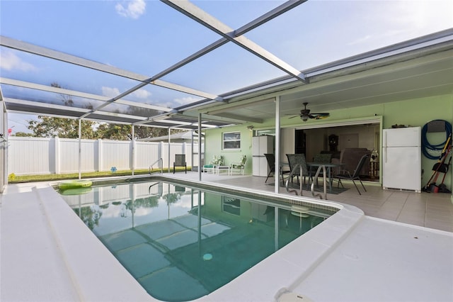 view of swimming pool with a patio, glass enclosure, fence, and a fenced in pool