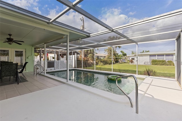 pool with a lanai, a ceiling fan, a lawn, and a patio