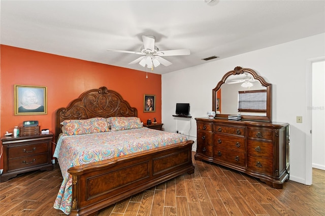 bedroom with dark wood-style floors, baseboards, visible vents, and ceiling fan