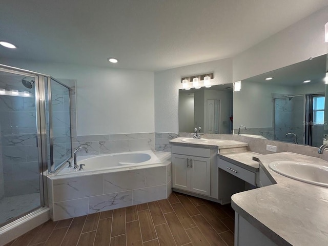 141 W 6th St, Frostproof, FL 33843 - full bathroom with a shower stall, a garden tub, vanity, recessed lighting, and wood tiled floors