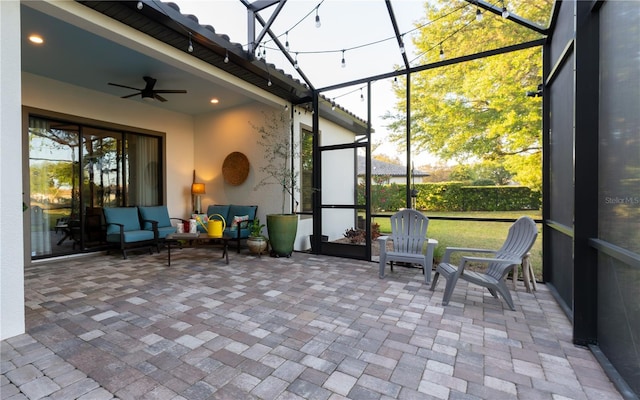 sunroom / solarium with outdoor lounge area, a healthy amount of sunlight, and a ceiling fan